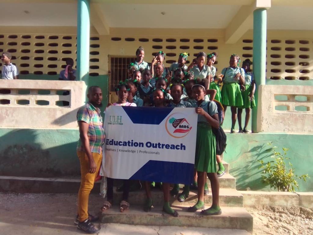 Students with the education outreach banner