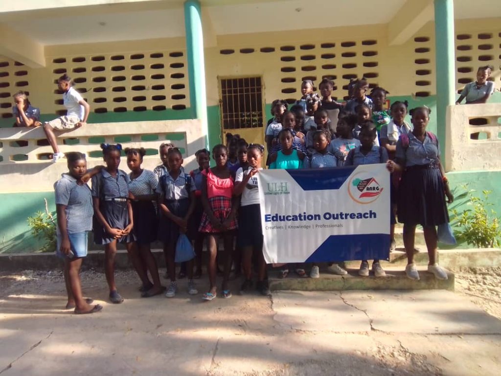 School outreach group outside a school building