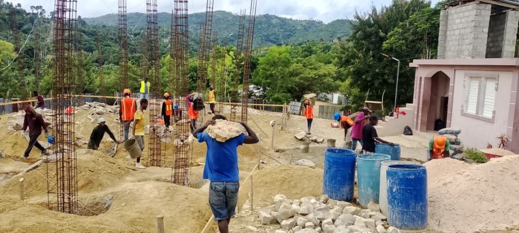 Workers at the church foundation construction site