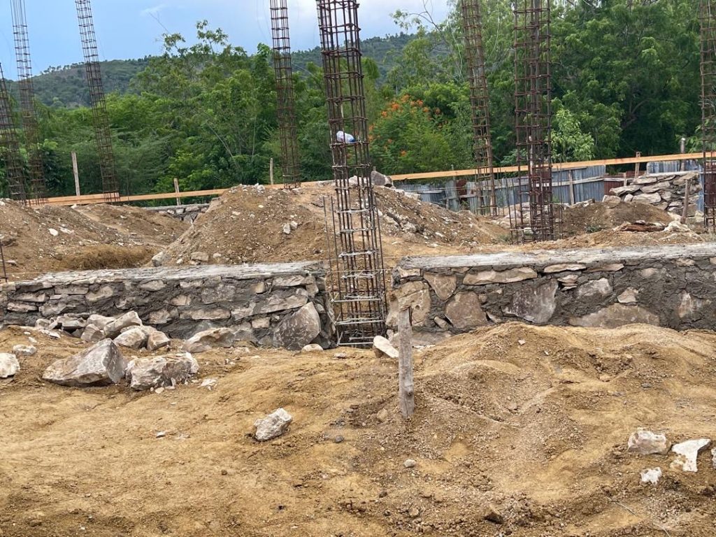 Foundation walls and column cages across the construction site