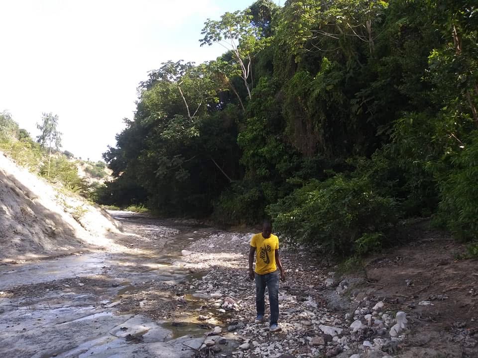 Community member working on a rural road in Ginode, Haiti