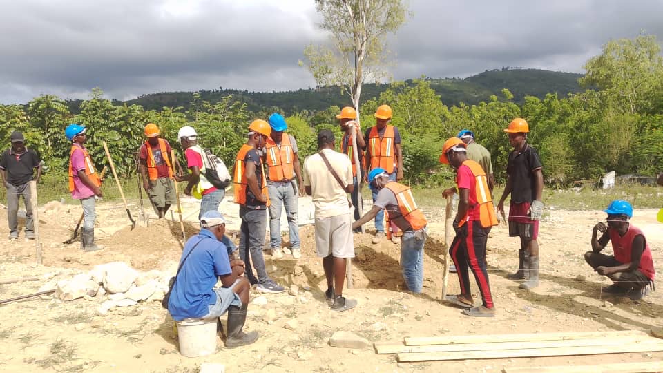 Material delivery supporting foundation work at the Sainte-Thérèse d’Avila church construction site in Guinaudée.